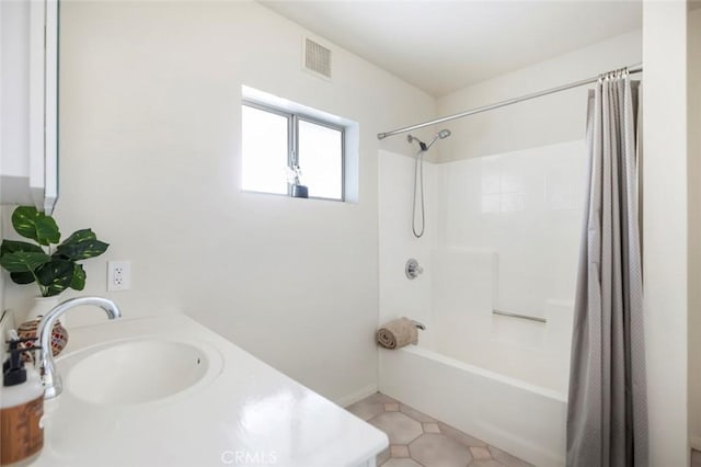 bathroom featuring shower / bathtub combination with curtain, sink, and tile patterned floors