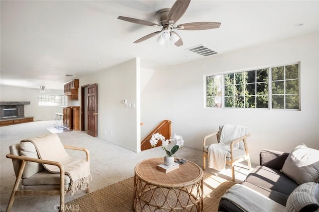 carpeted living room featuring ceiling fan