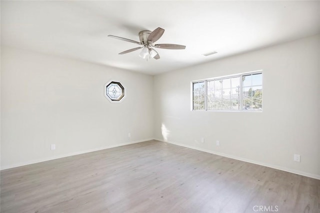 empty room with ceiling fan and light wood-type flooring