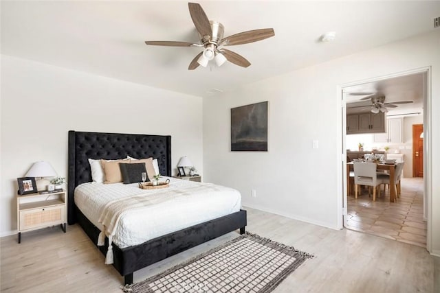 bedroom with ceiling fan and light hardwood / wood-style flooring