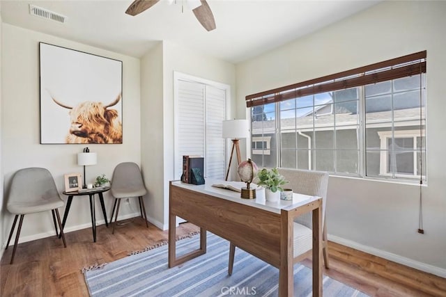 office with hardwood / wood-style flooring and ceiling fan