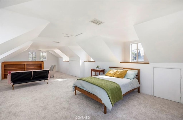 bedroom with light carpet and vaulted ceiling