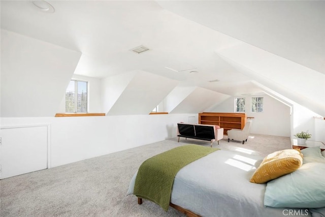 bedroom featuring lofted ceiling and light carpet