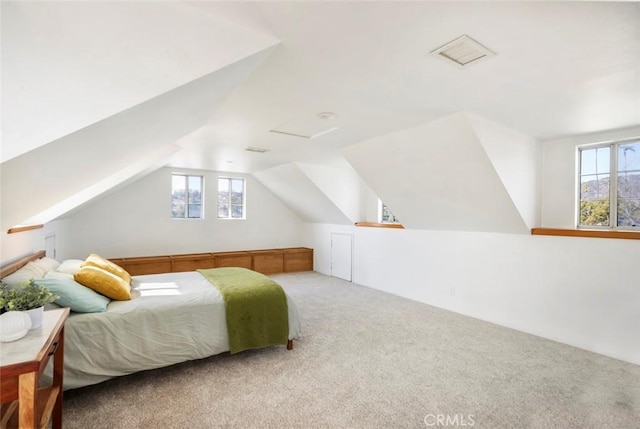 bedroom featuring vaulted ceiling and carpet flooring