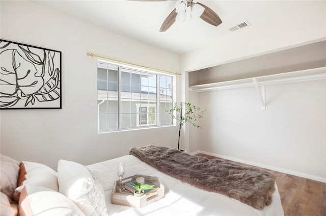 bedroom with wood-type flooring and ceiling fan