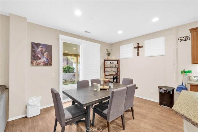 dining space with light hardwood / wood-style floors