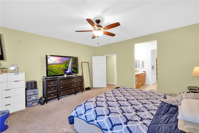 carpeted bedroom with ceiling fan and ensuite bathroom