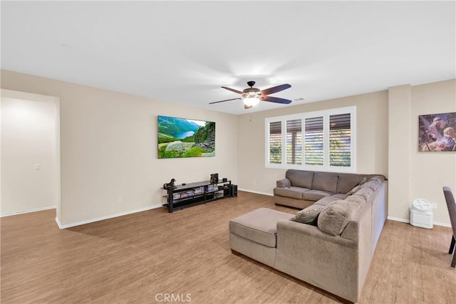 living room with ceiling fan and light wood-type flooring