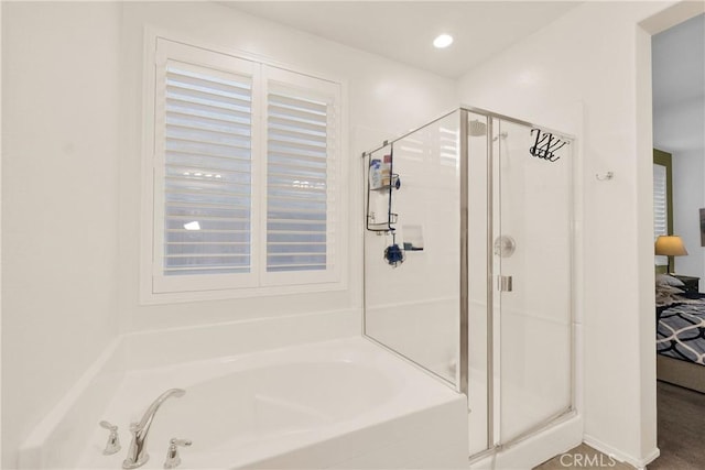 bathroom with shower with separate bathtub