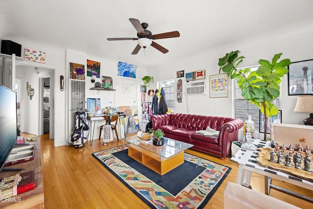 living room featuring ceiling fan and wood-type flooring