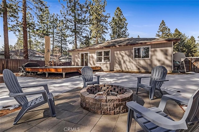 view of patio featuring fence and an outdoor fire pit