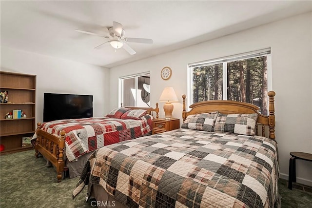 bedroom featuring multiple windows, carpet floors, and ceiling fan