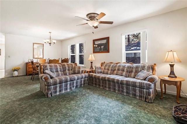 living room featuring ceiling fan with notable chandelier, carpet, and baseboards