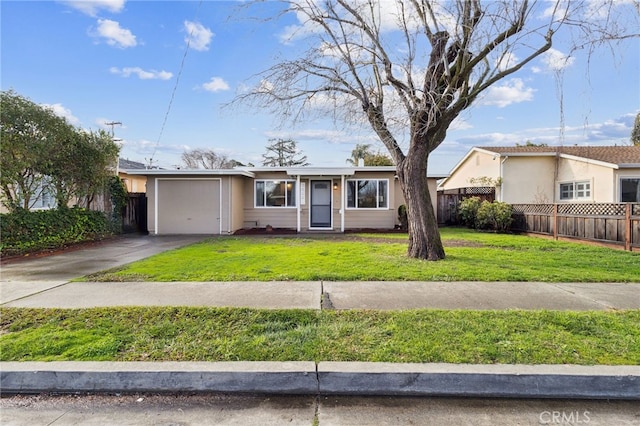 view of front of property featuring aphalt driveway, a front lawn, an attached garage, and fence