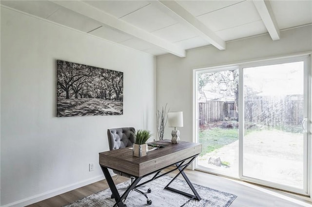 office area featuring plenty of natural light, beam ceiling, baseboards, and wood finished floors