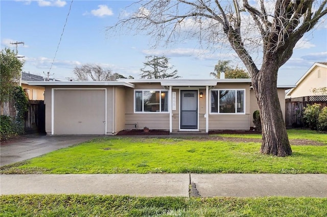 view of front of home with a front yard, driveway, a garage, and fence