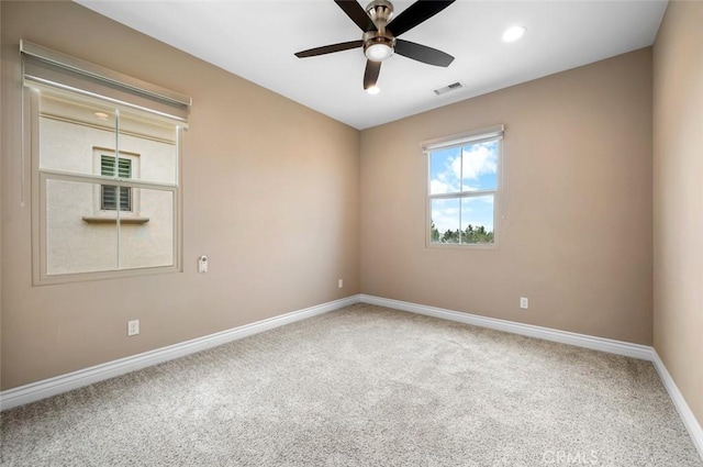 carpeted empty room with a ceiling fan, recessed lighting, visible vents, and baseboards