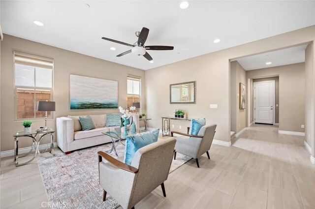 living area with a wealth of natural light and baseboards