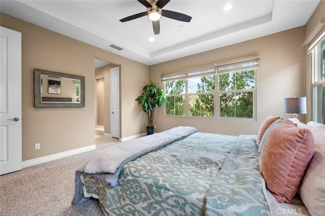 bedroom featuring carpet, baseboards, visible vents, and a raised ceiling