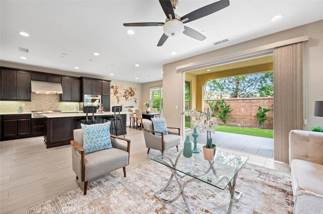 living area featuring visible vents and recessed lighting