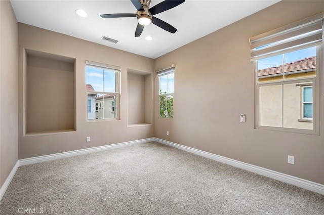 carpeted spare room featuring visible vents, baseboards, a ceiling fan, and recessed lighting