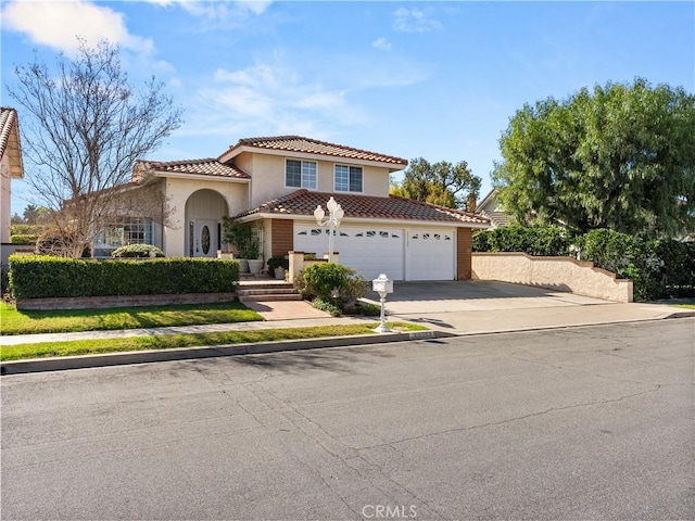 mediterranean / spanish-style house with a garage