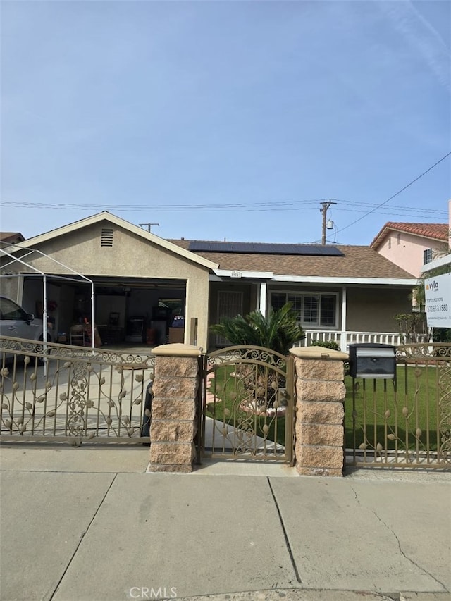 view of front of house featuring a garage and solar panels