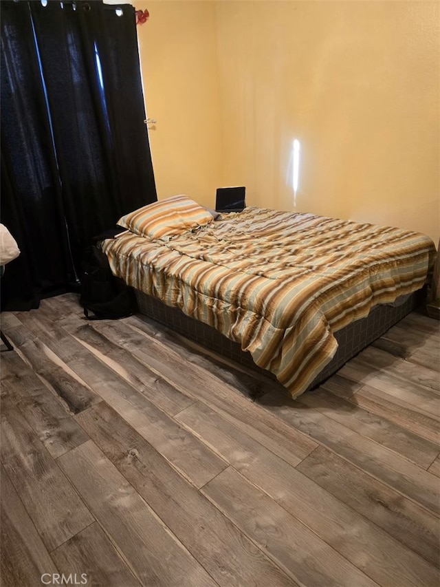 bedroom with hardwood / wood-style floors