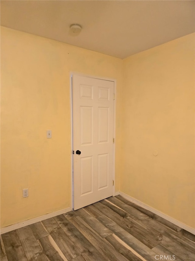 unfurnished room featuring dark wood-type flooring