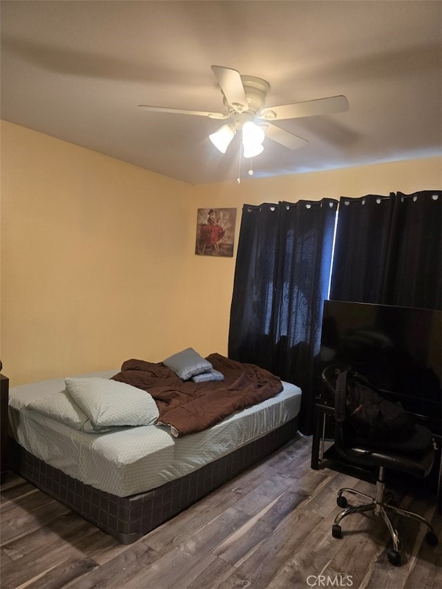 bedroom with hardwood / wood-style flooring and ceiling fan