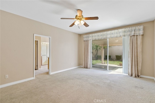 spare room with ceiling fan and light carpet