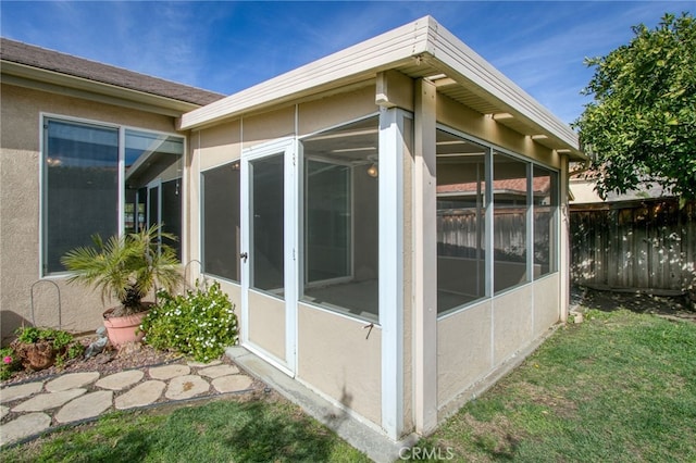 view of side of home with a yard and a sunroom