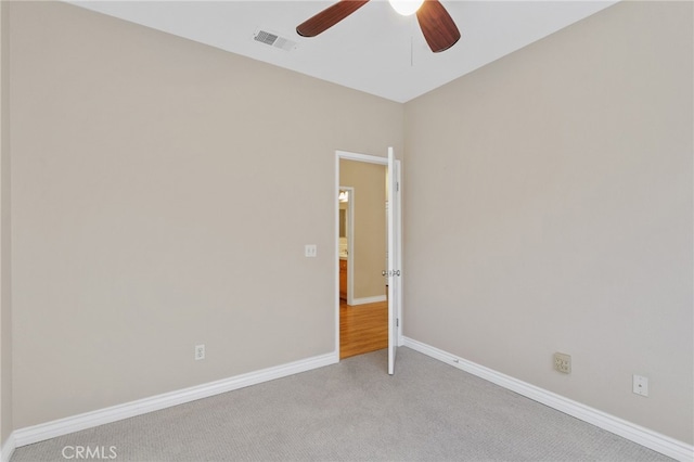 empty room with light colored carpet and ceiling fan