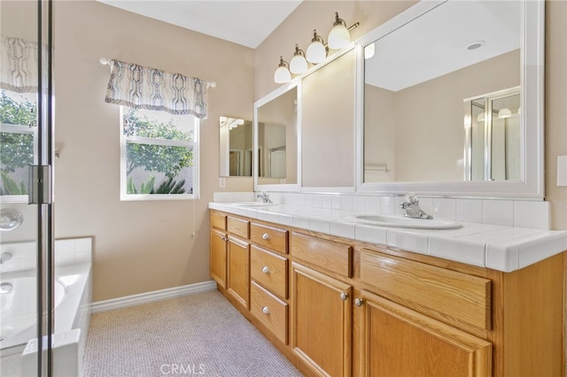 bathroom with vanity and independent shower and bath