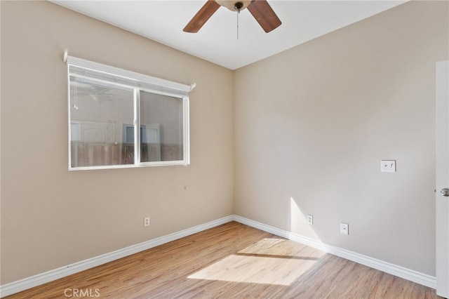 spare room featuring hardwood / wood-style flooring and ceiling fan