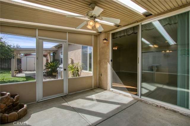 unfurnished sunroom featuring ceiling fan