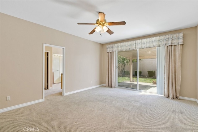 spare room with ceiling fan and light carpet