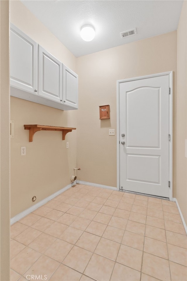 clothes washing area featuring cabinets