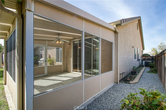 view of side of property with cooling unit and ceiling fan