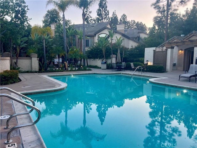 pool featuring a patio and fence