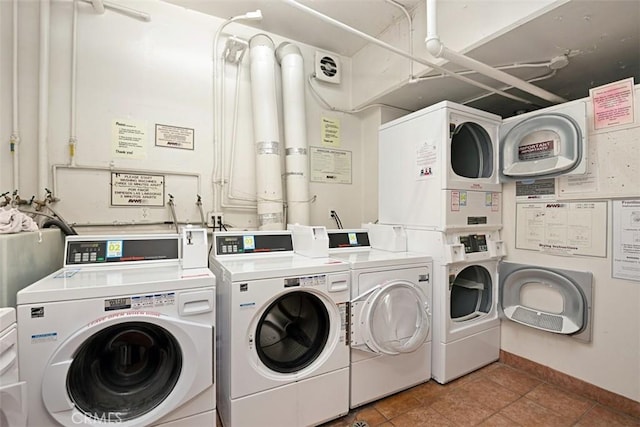 clothes washing area with tile patterned flooring, washing machine and dryer, and stacked washer / drying machine