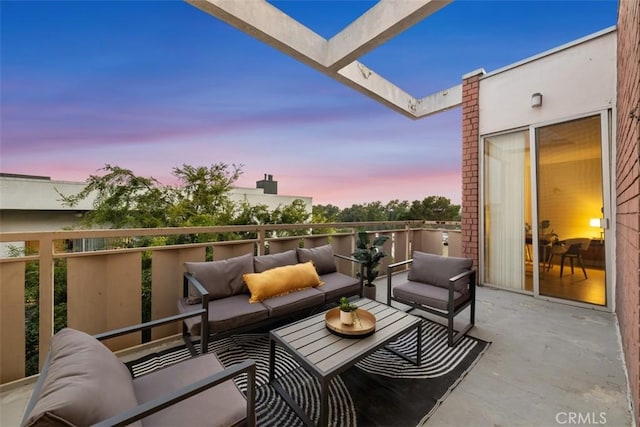 balcony at dusk featuring an outdoor hangout area