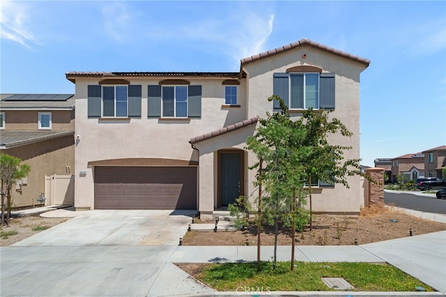 mediterranean / spanish-style home featuring a garage