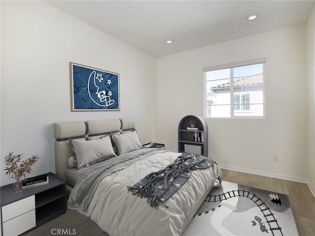 bedroom featuring baseboards, recessed lighting, and wood finished floors