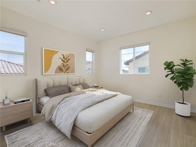 bedroom with recessed lighting, baseboards, and light wood-style flooring