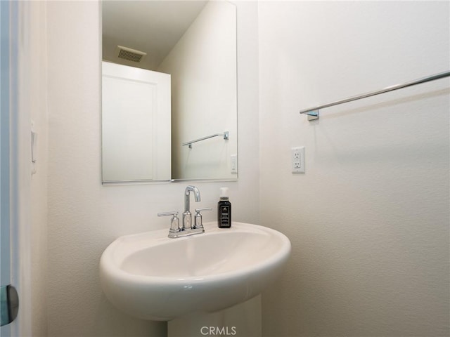 bathroom featuring a sink and visible vents