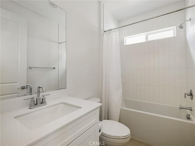 bathroom with shower / bath combo with shower curtain, toilet, and vanity