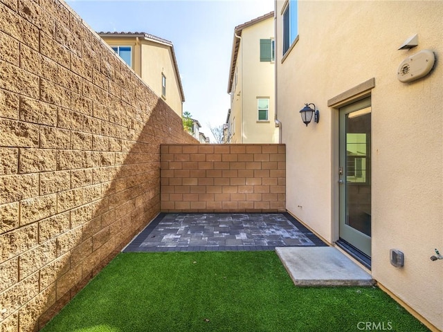 view of yard featuring fence and a patio area