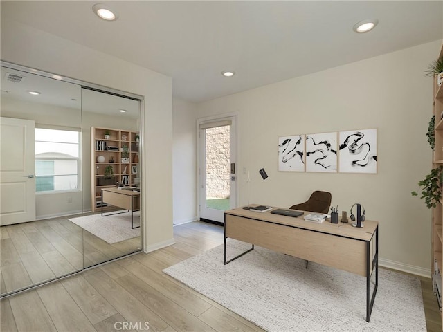office featuring recessed lighting, baseboards, visible vents, and light wood finished floors