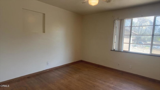 empty room with hardwood / wood-style floors and plenty of natural light